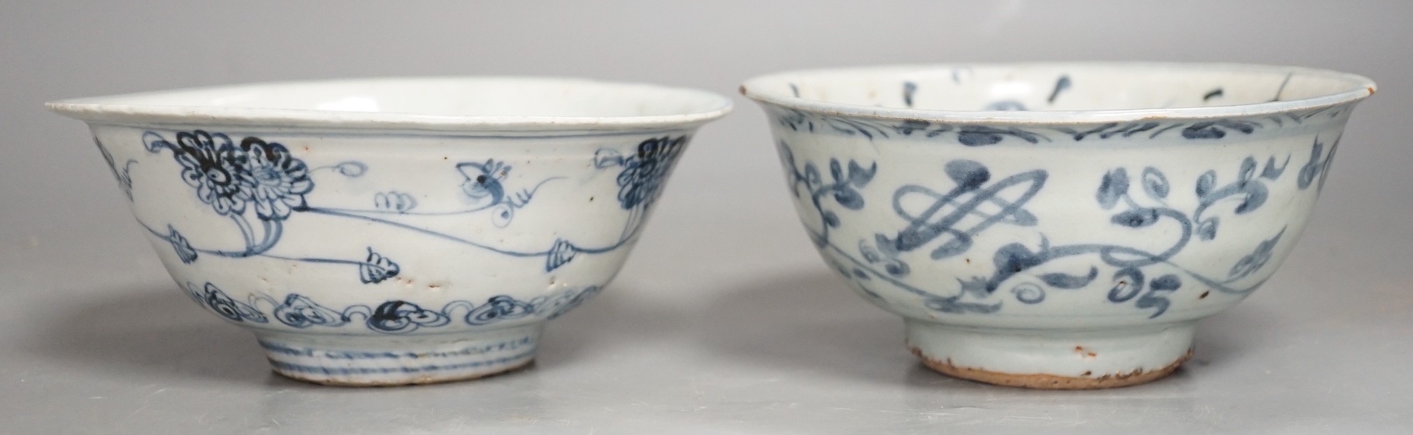 Two Chinese late Ming blue and white bowls, 16th/17th century, painted with flowers and foliage, 14.3 and 15.8cm